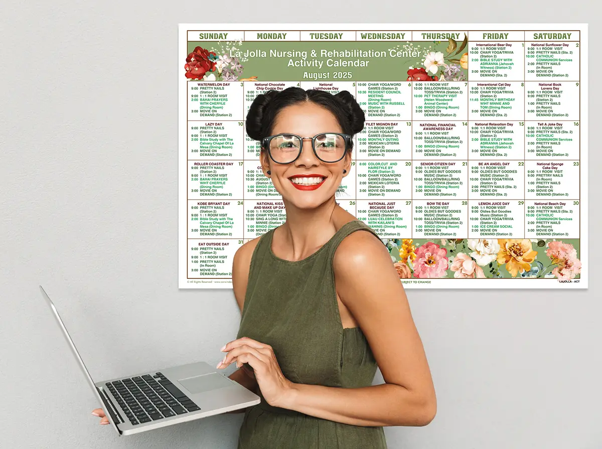 Woman using laptop in front of MyCorwin calendar printed on wall